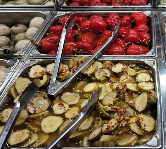 Harold's world-famous pickle bar — trays of pickles and pickled peppers
